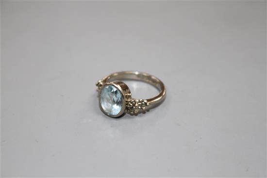 A modern 18ct white gold, aquamarine and marcasite set dress ring, size N, gross weight 5.8 grams.